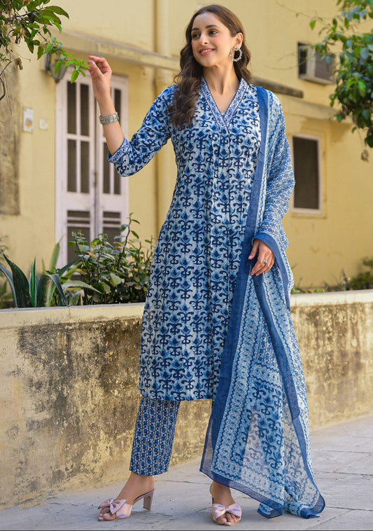 Woman wearing a blue floral outfit standing outdoors.